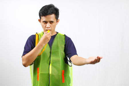 Young asian man wearing a green construction vest