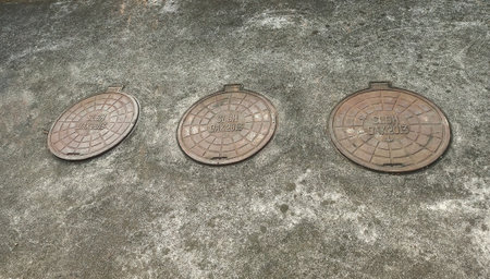 Manhole cover on the ground in the city of Bangkok, Thailand.