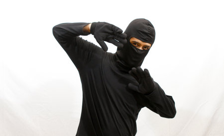 Ninja in black mask and black clothes isolated on white background.