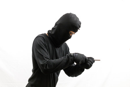 Masked person using a cell phone. Isolated on white background.
