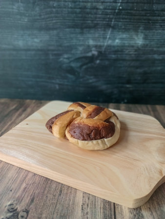 Bread on wooden board with dark background. Bakery concept.