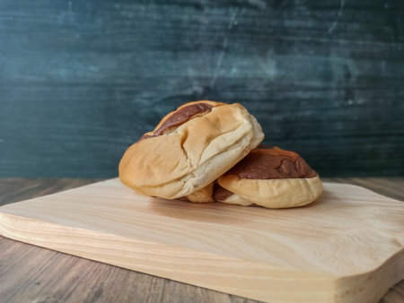 Bread buns on a wooden cutting board on a dark backgroundの写真素材