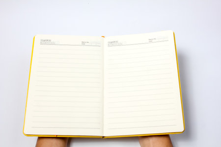 Notebook with blank pages on white background, top view, copy space