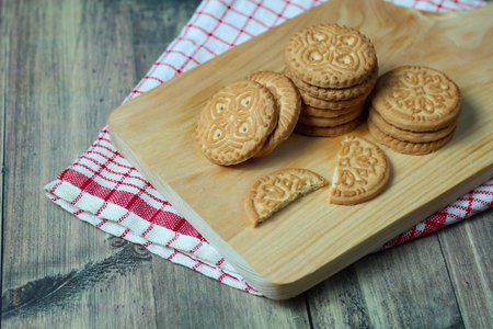 cookies with chocolate filling on a wooden board. tinting. selective focus