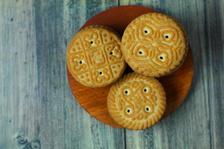 Moon cakes on wooden plate, top view. Close-up.