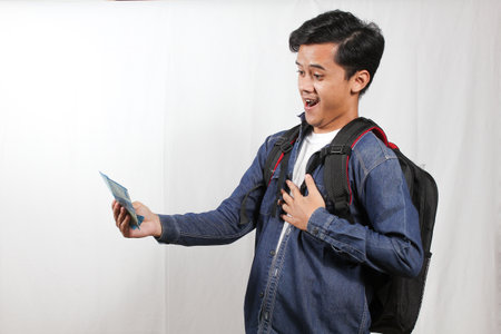 Portrait of a happy young asian man with backpack