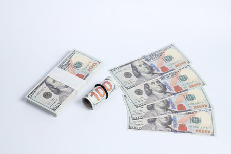 Money isolated on white background. One hundred dollar bills and one hundred dollar bill.