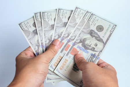 Hands counting money on white background, business and finance concept.