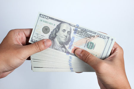 Hands holding dollars banknote isolated on white background with clipping path