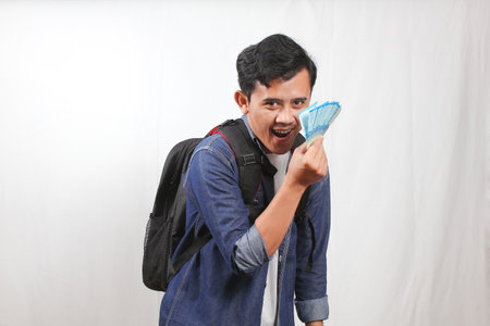 asian man with backpack on the white background.の写真素材