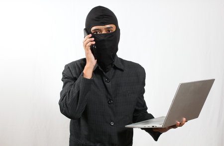 Young asian man using laptop on white background
