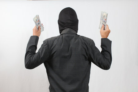 Rear view of asian business man counting money on white background