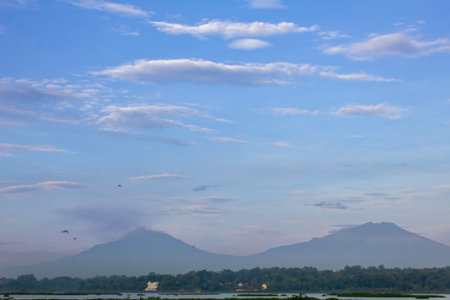 Landscape view of mountain and blue sky with white clouds at sunset.