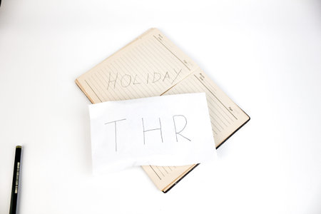 Notebook and pencil on a white backgroundの写真素材