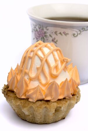 Cup of tea and cakes on a plate on a white background it is isolatedの写真素材