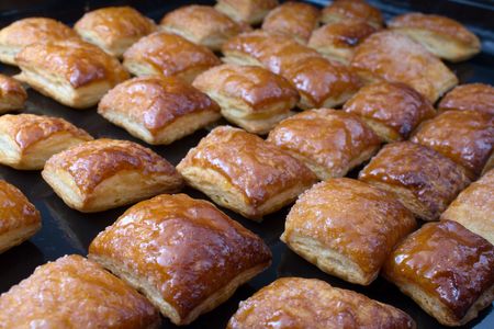 Fresh cookies just from an oven on a black sheetの写真素材