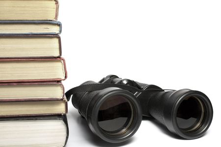 field-glass and heap of books, tool for information search.の写真素材