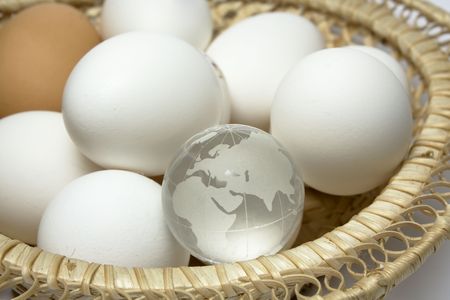 Wum basket with chicken eggs and glass globeの写真素材