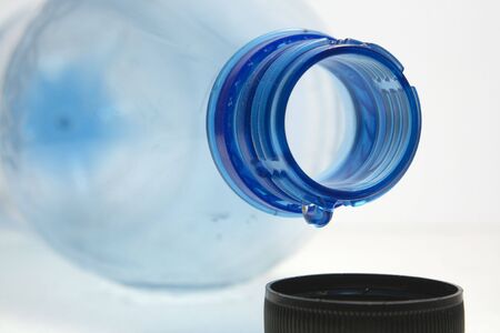 last drop of empty water bottle on white backgroundの写真素材