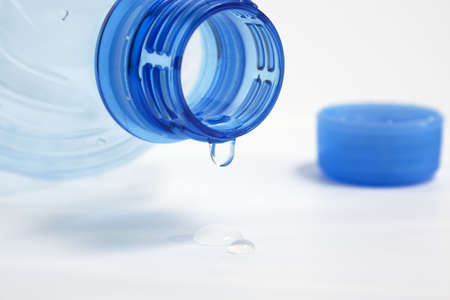 last drop of empty water bottle on white background