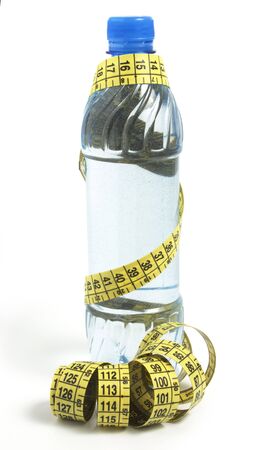 bottle and tape measure isolated on whiteの写真素材