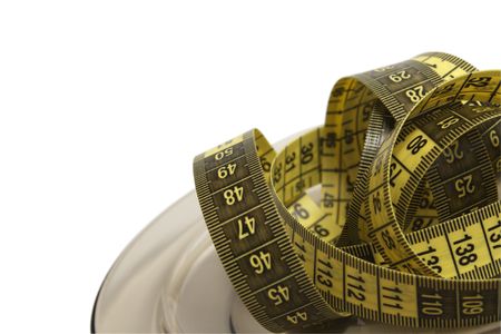 Plate with measuring tape isolated on white