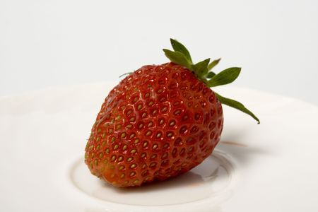 Fresh and tasty strawberries on white plateの写真素材