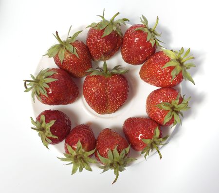 Fresh and tasty strawberries on white plateの写真素材