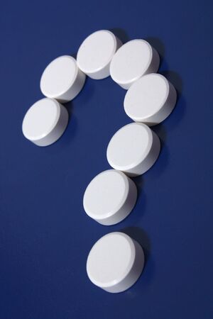 Question mark of white tablets on dark blue background.の写真素材