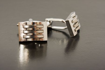 stainless steel cufflinks on the black backgroundの写真素材