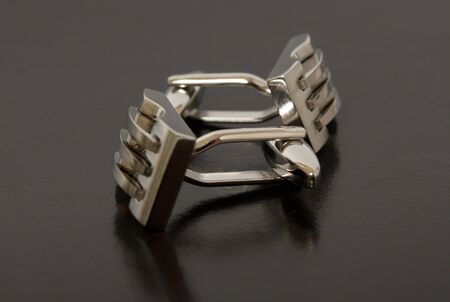 stainless steel cufflinks on the black backgroundの写真素材