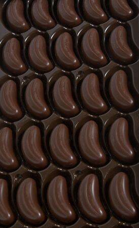 Box of chocolates inside. Dark chocolate in brown package.の写真素材