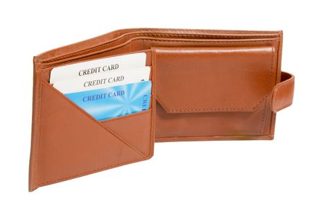 opened brown leather wallet with credit cards isolated on whiteの写真素材