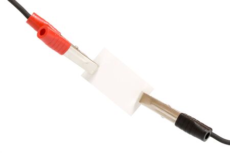 Automotive jumper cables attached to a blank sign, for your text or graphics.の写真素材