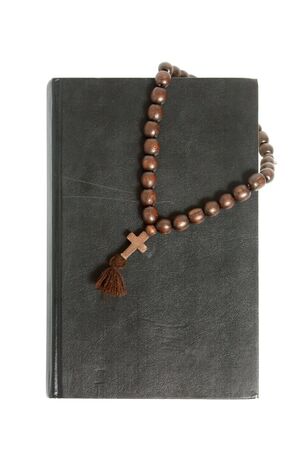 black bible and wooden cross isolated on white backgroundの写真素材