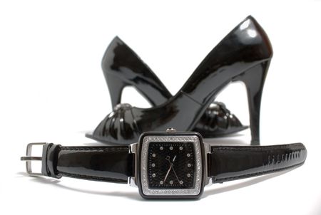 Ladies' watch and high heels shoes on whiteの写真素材