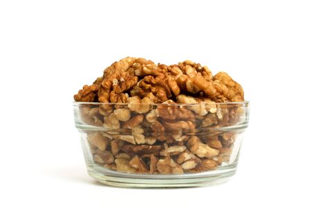 Walnut in glass dish isolated on whiteの写真素材