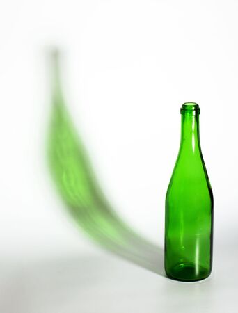 open empty champagne bottle with green shadowの写真素材