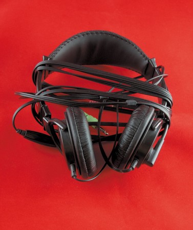 a stereo headphones on red backgroundの写真素材