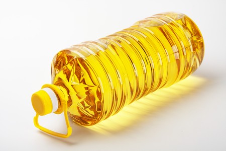 Bottle of sunflower oil on a white tableの写真素材
