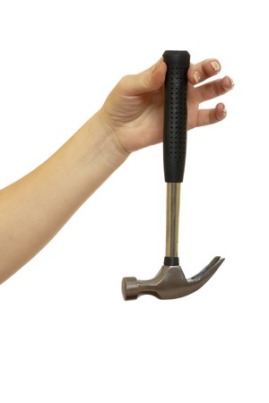 hammer in a beautiful female hand isolated on white backgroundの写真素材