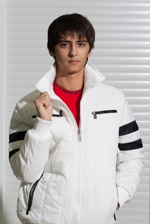 Portrait of a handsome young man of sixteen. Youth shows autumn, winter clothing.の写真素材