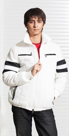 Portrait of a handsome young man of sixteen. Youth shows autumn, winter clothing.の写真素材