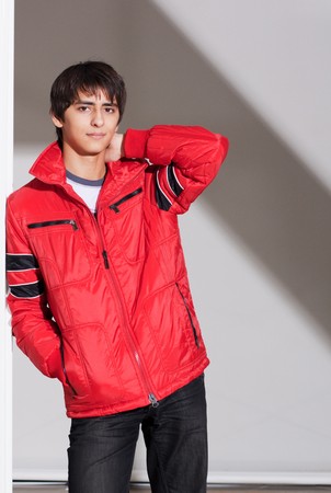 Portrait of a handsome young man of sixteen. Youth shows autumn, winter clothing.の写真素材
