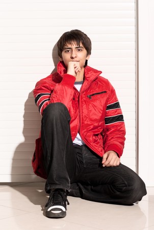 Portrait of a handsome young man of sixteen. Youth shows autumn, winter clothing.の写真素材