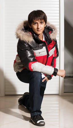 Portrait of a handsome young man of sixteen. Youth shows autumn, winter clothing.の写真素材