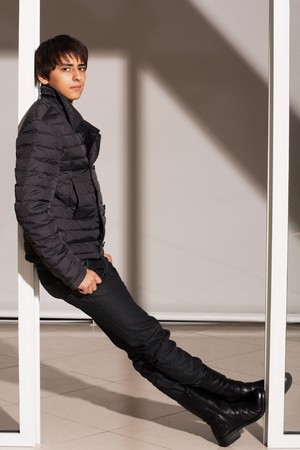 Portrait of a handsome young man of sixteen. Youth shows autumn, winter clothing.の写真素材