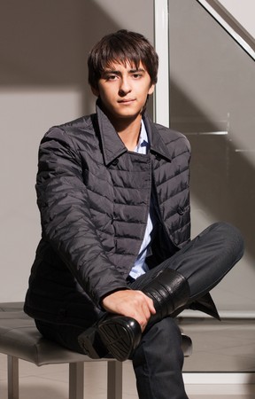 Portrait of a handsome young man of sixteen. Youth shows autumn, winter clothing.の写真素材