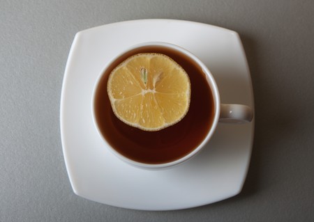 Cup of Tea with lemon slice on gray tableの写真素材