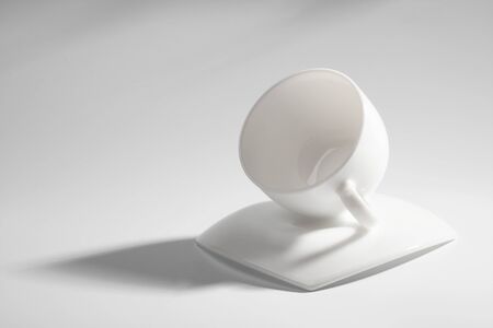 An empty coffee cup on a gray background with shadowの写真素材